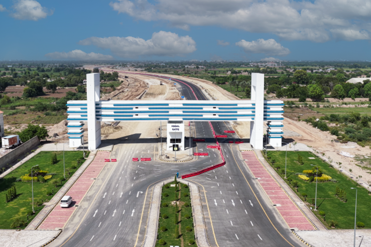 Aerial view of DHA Multan Iqbal Gate showing green horticulture developed residential sectors, wide road network